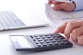 A digital calculator with a clear display showing numbers and various function buttons, including addition, subtraction, multiplication, division, and memory functions, placed on a flat surface.