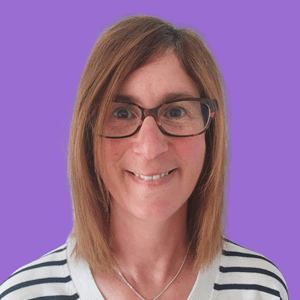 Smiling woman with straight, shoulder-length brown hair and glasses, wearing a striped shirt.