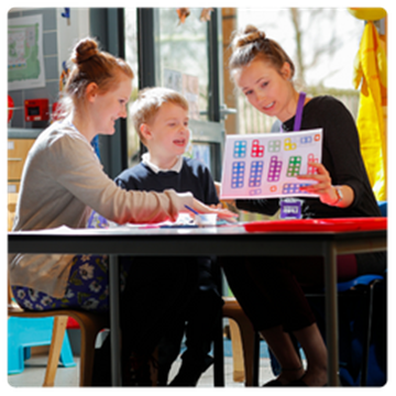 teachers with maths workbook