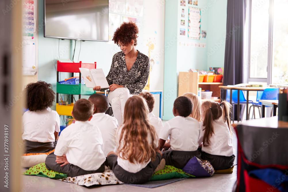 ALT - Teacher reading in front of children