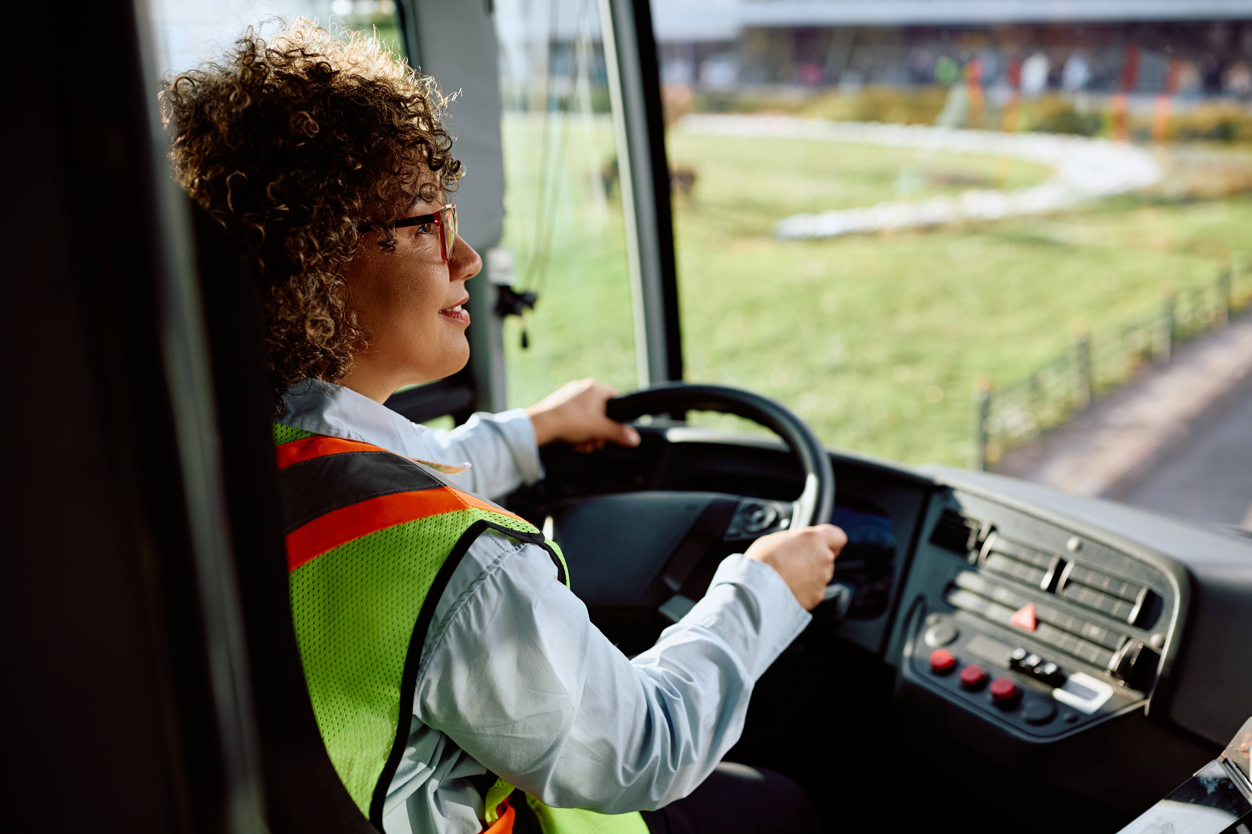ALT - Lady driving a mini bus